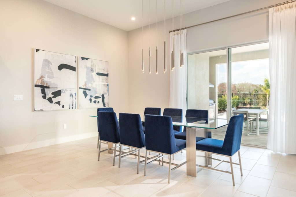 Spacious dining room with access to backyard lanai and private pool in an elegant 8-bedroom Bear’s Den Resort Orlando residence.