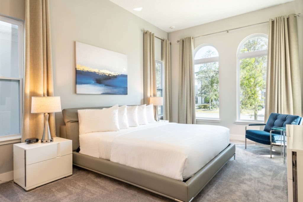 Spacious bedroom with large king bed at an elegant 8-bedroom Bear’s Den Resort Orlando residence.