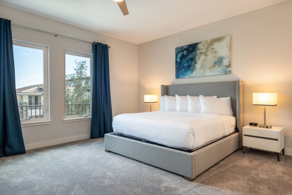 Spacious bedroom with large king bed in an elegant 8-bedroom Bear’s Den Resort Orlando residence.