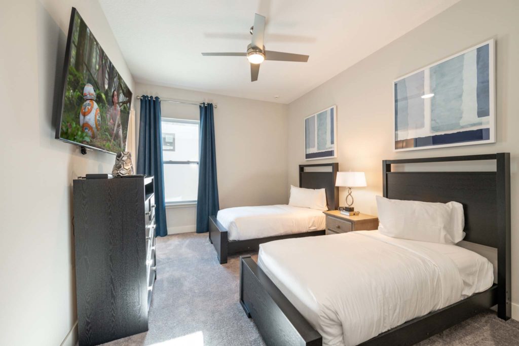 Two queen beds in an elegant 8-bedroom Bear’s Den Resort Orlando residence.