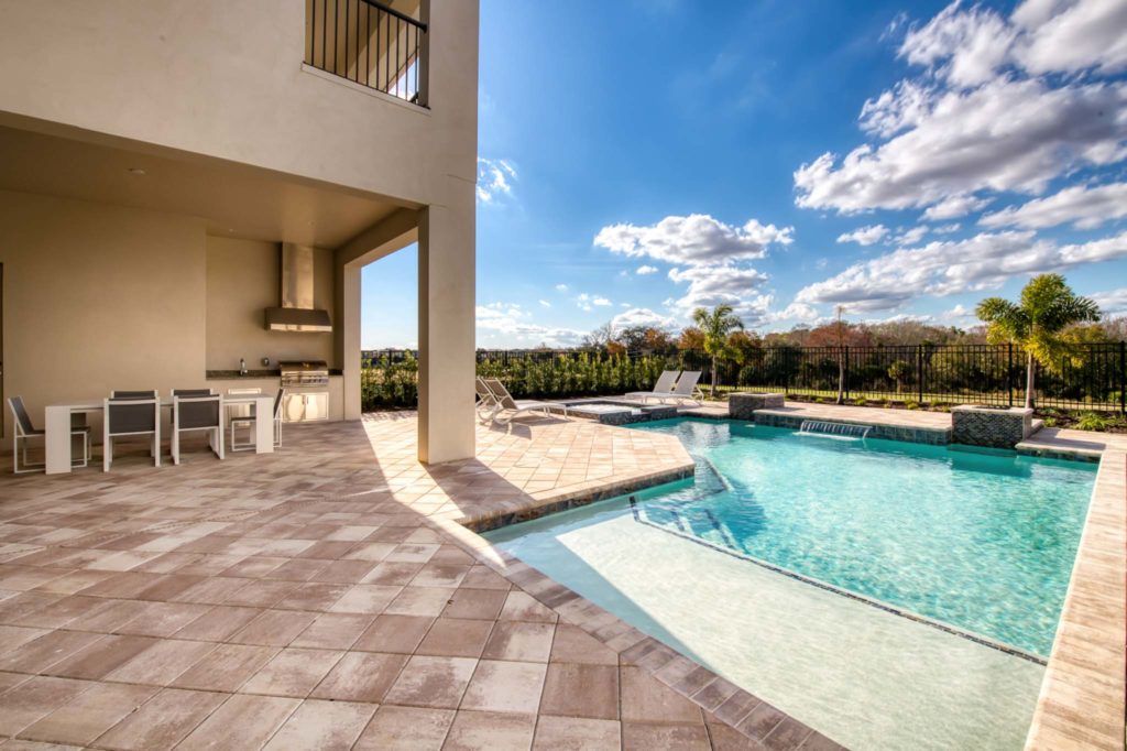 Private pool and covered summer kitchen at an elegant 8-bedroom Bear’s Den Resort Orlando residence.