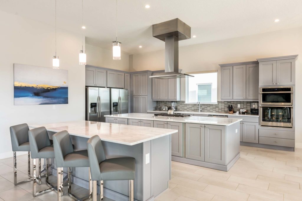 Deluxe kitchen with two islands and barstool seating.