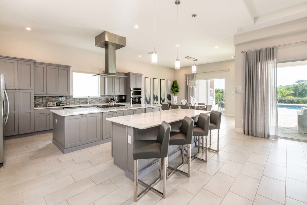 Large kitchen and dining room with sliding door access to backyard lanai and private pool.