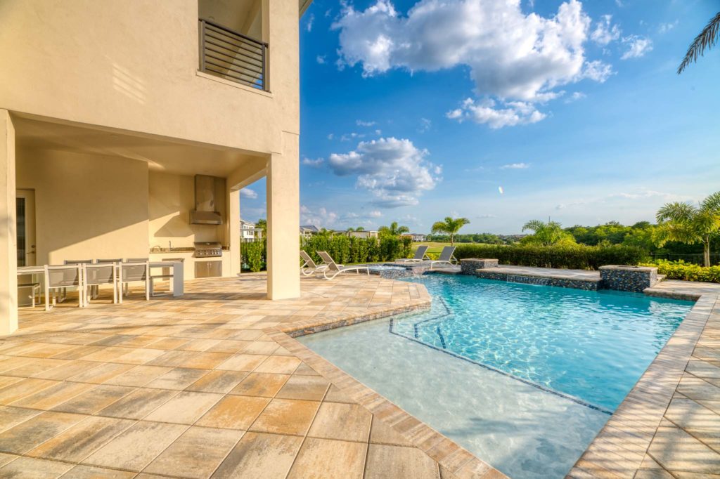 Private backyard patio with pool and covered summer kitchen.