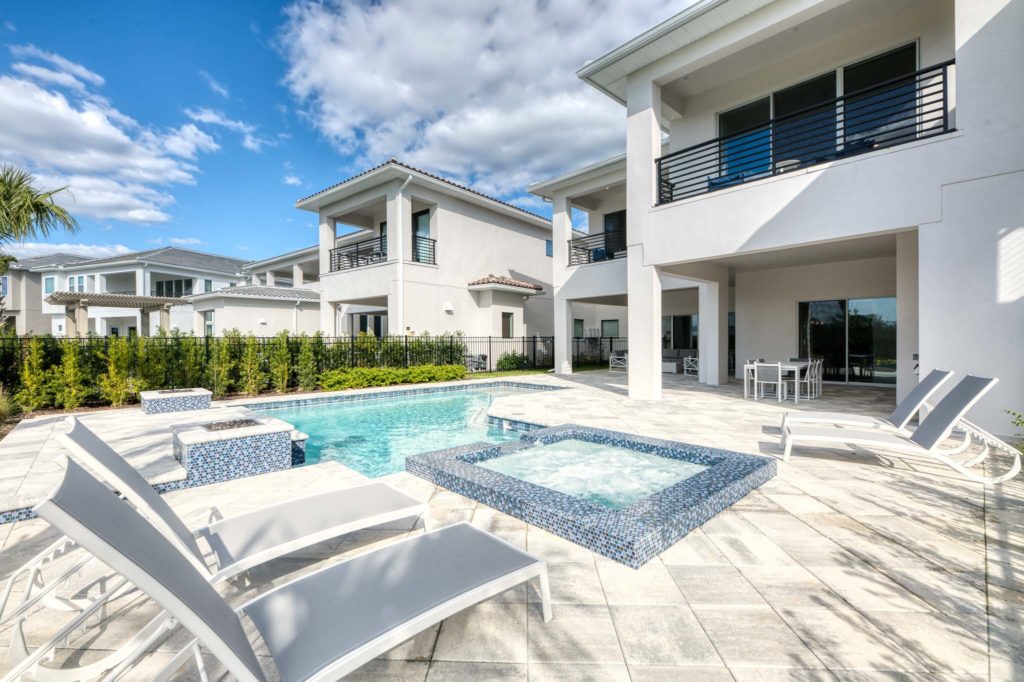 Private backyard patio with pool, spa, and lounge chairs.