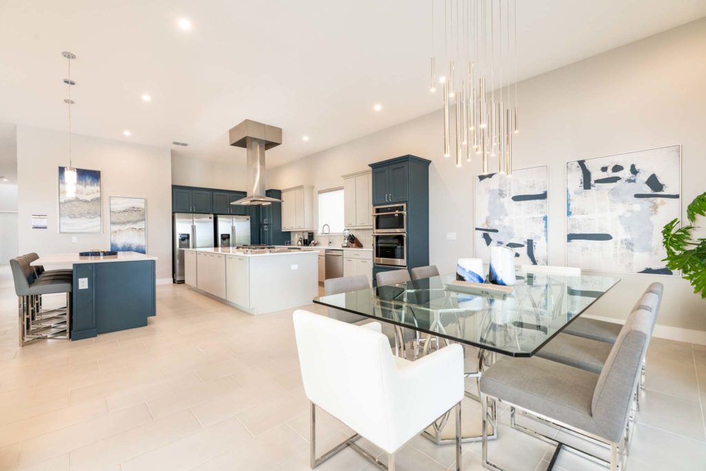 Spacious dining room and kitchen with modern lighting and decor.