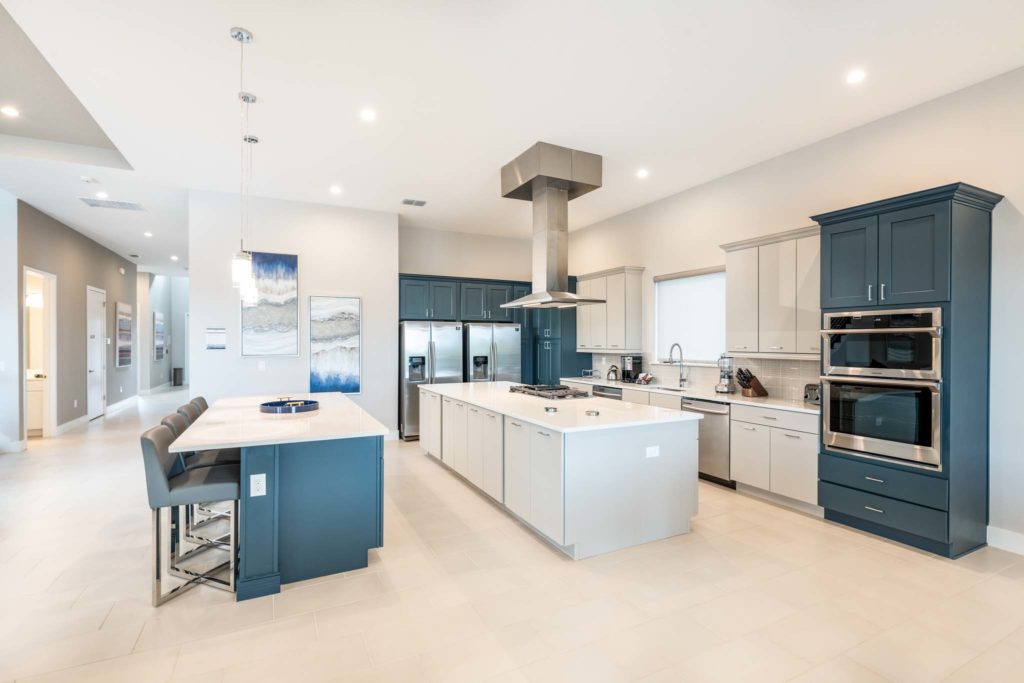 Spacious kitchen with two islands and barstool seating.