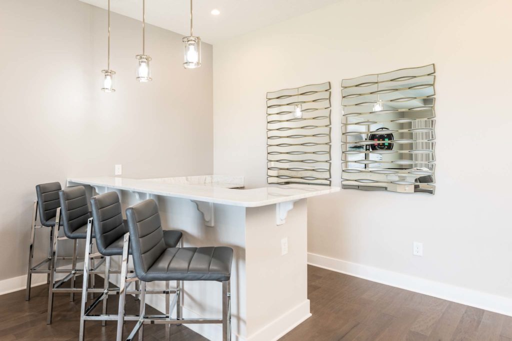 Dry bar with barstool seats in the upper loft.