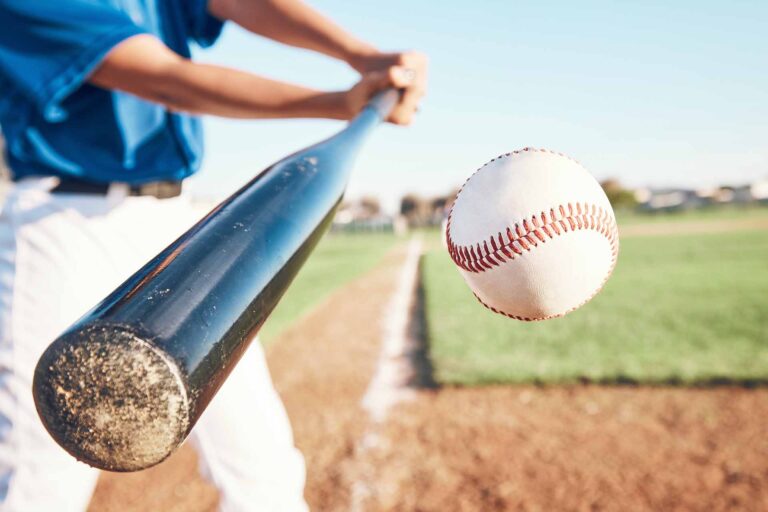 Baseball player about to hit a baseball with a bat