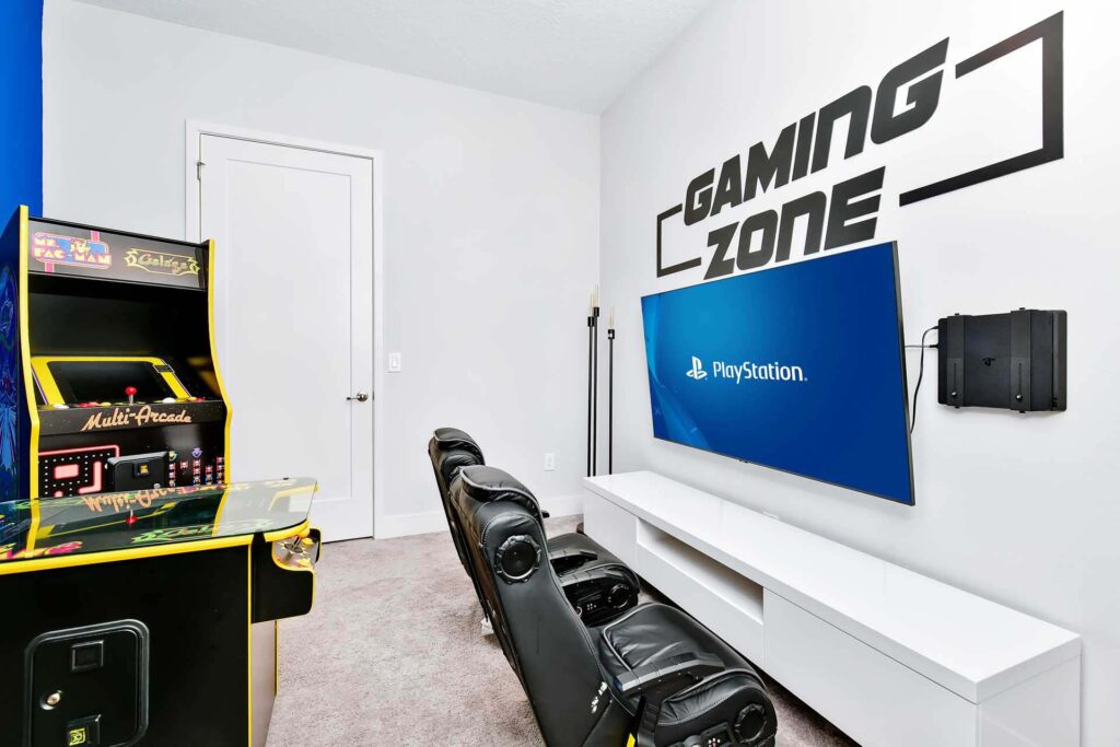 Game room with video gaming area and arcade machines at an elegant 8-bedroom Bear’s Den Resort Orlando residence