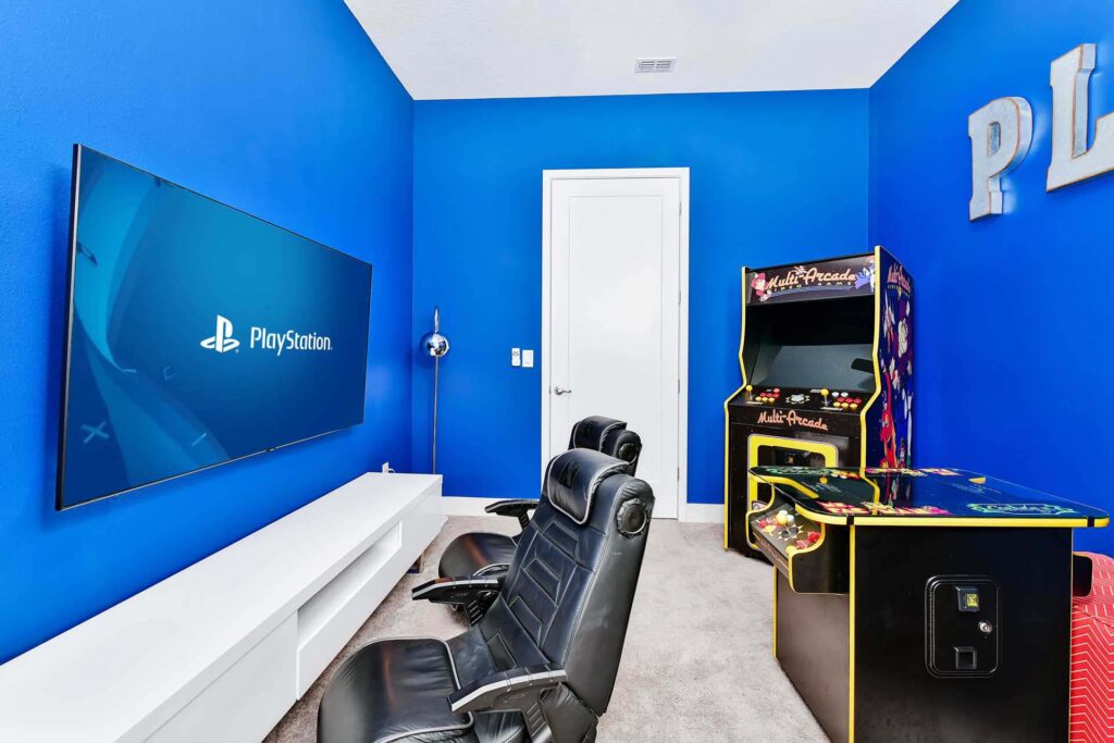 Game room with video gaming area and arcade machines at an enormous 8-bedroom Bear’s Den Resort Orlando residence