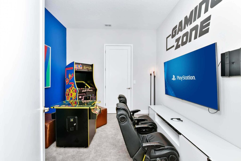 Game room with video gaming area and arcade machines at a superb 8-bedroom Bear’s Den Resort Orlando residence