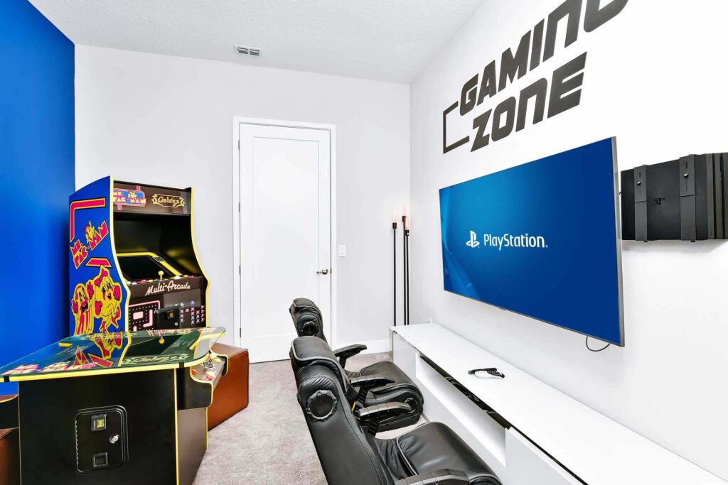Game room with video gaming area and arcade machines at a superb 8-bedroom Bear’s Den Resort Orlando residence