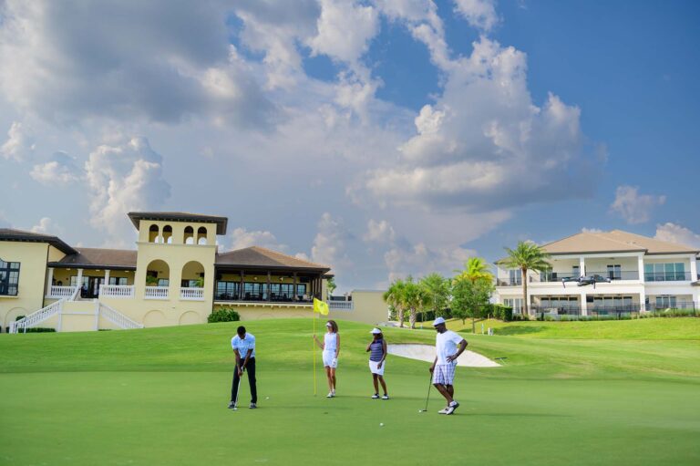 Family playing a round of gold near the Nicklaus Clubhouse at Bear's Den Resort