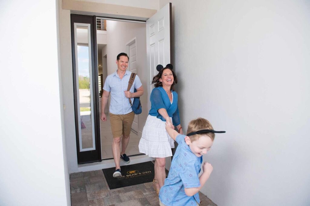 Family walking out of their Bear's Den Resort home, wearing Mickey Mouse ears, heading to the theme parks