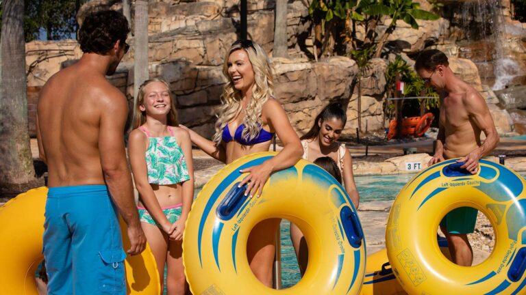 Family with pool tubes at a water park