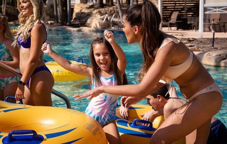 Happy little girl in a lazy river at a water park
