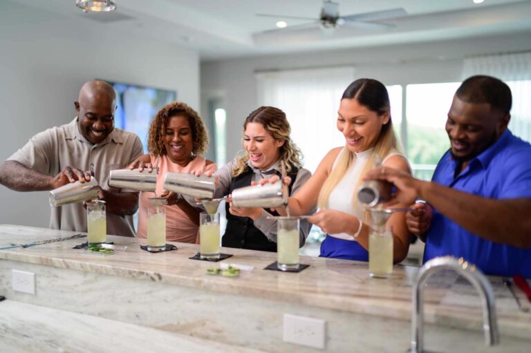 Group mixing cocktails in their private Bear's Den Resort home kitchen for a bartender experience.