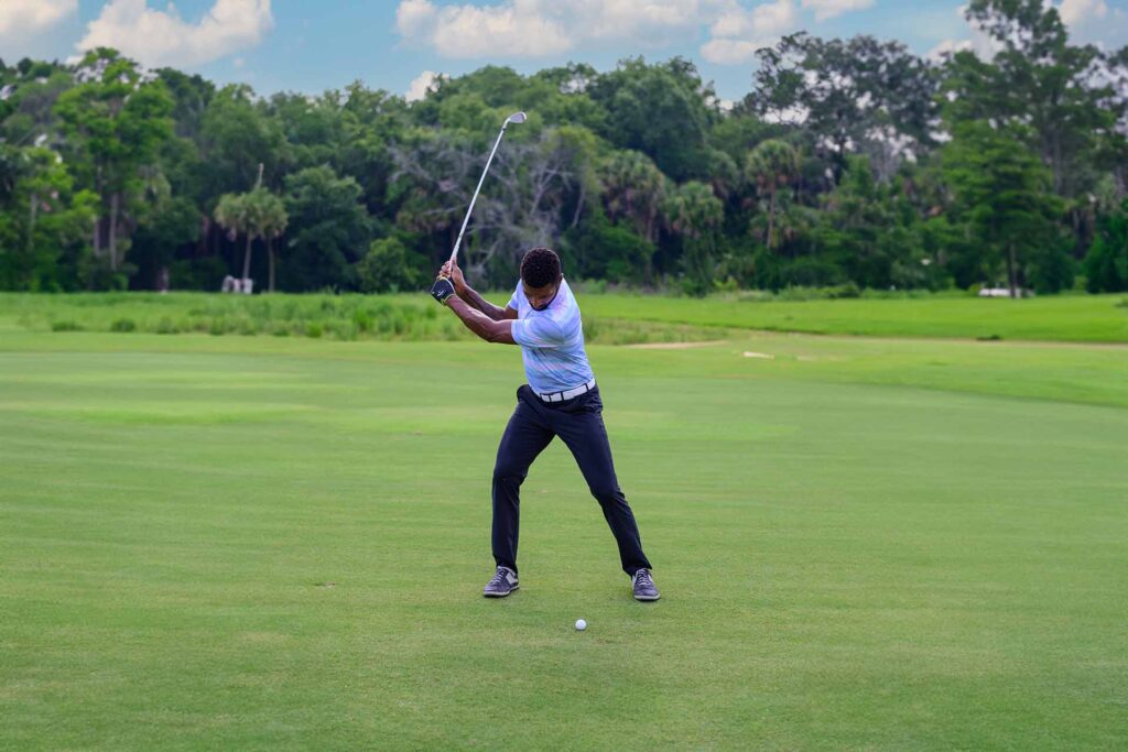 Man playing a round of golf at the Bear's Den Resort