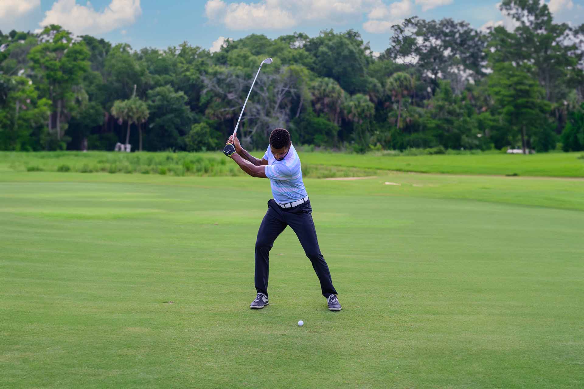 Man playing a round of golf at the Bear's Den Resort