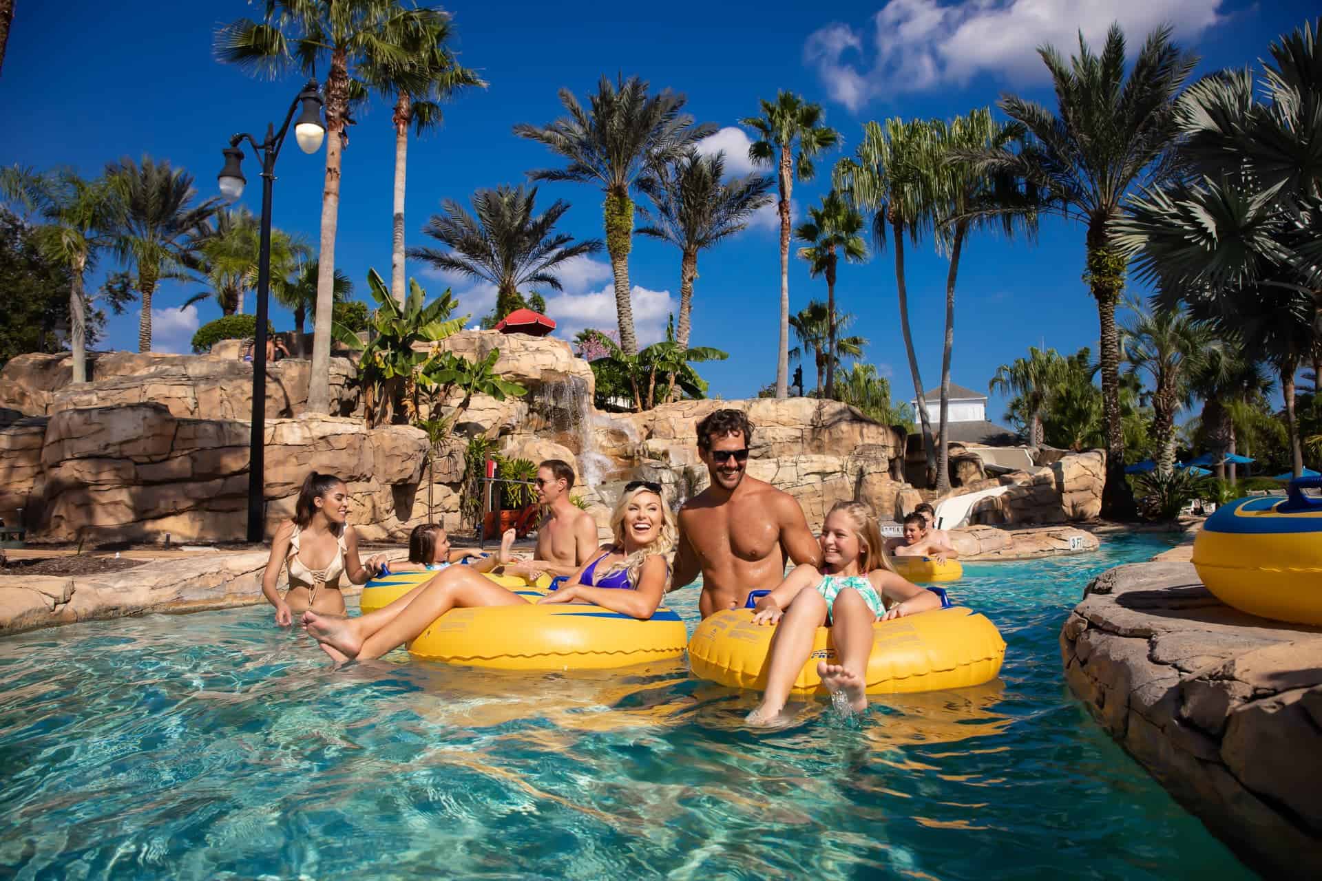 Families riding in tubes on the lazy river ride at the water park at The Bear’s Den Resort Orlando.