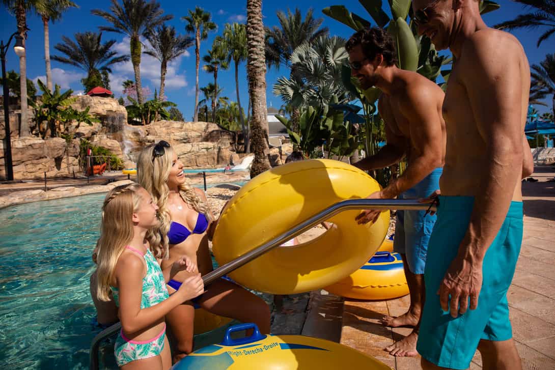 Reunion Resort water park: Family smiles while entering the lazy river ride.