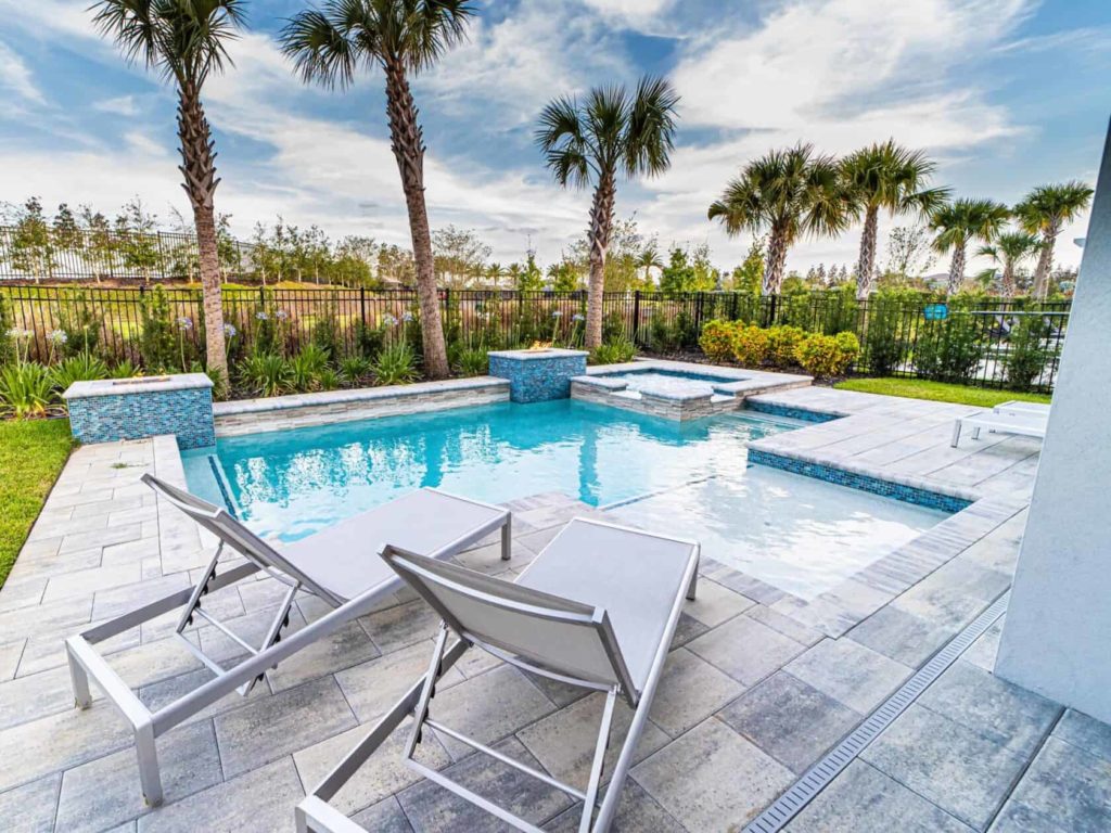 Private pool with lounge chairs in the backyard of a Bear’s Den Resort Orlando curated resort residence.