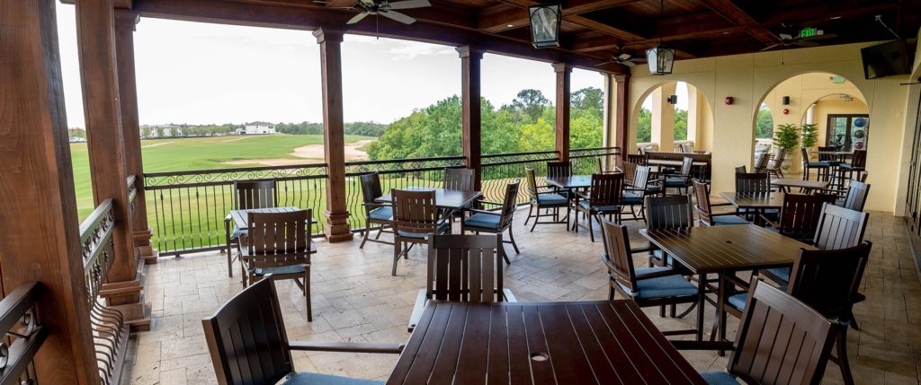 Covered outdoor seating at Traditions restaurant, overlooking the Jack Nicklaus golf course.