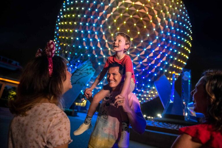 Young boy sitting on father's shoulders outside Spaceship Earth at EPCOT