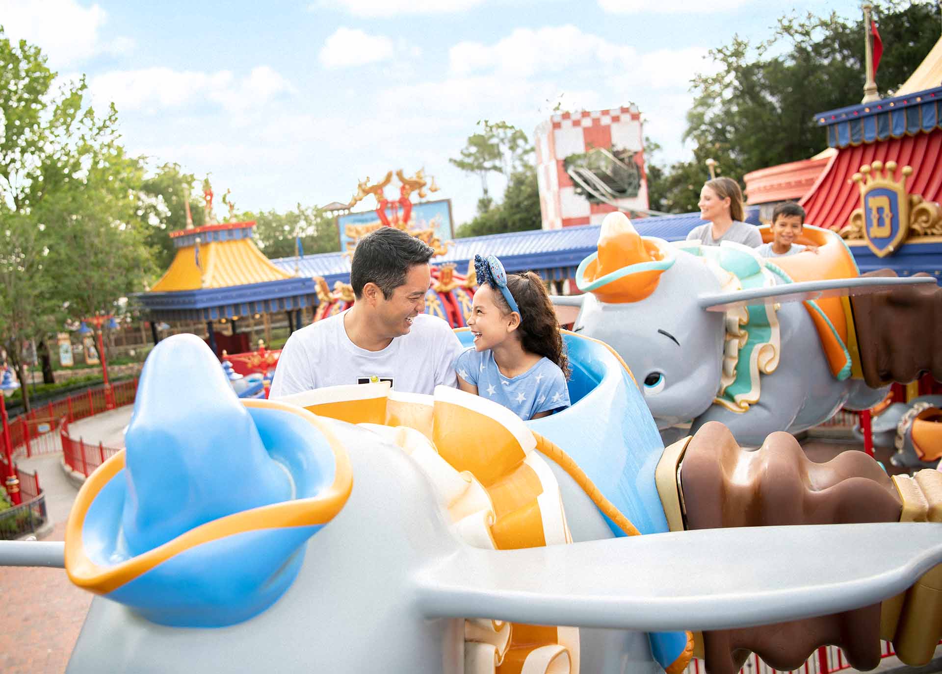 Father and daughter riding Dumbo at Disney's Magic Kingdom