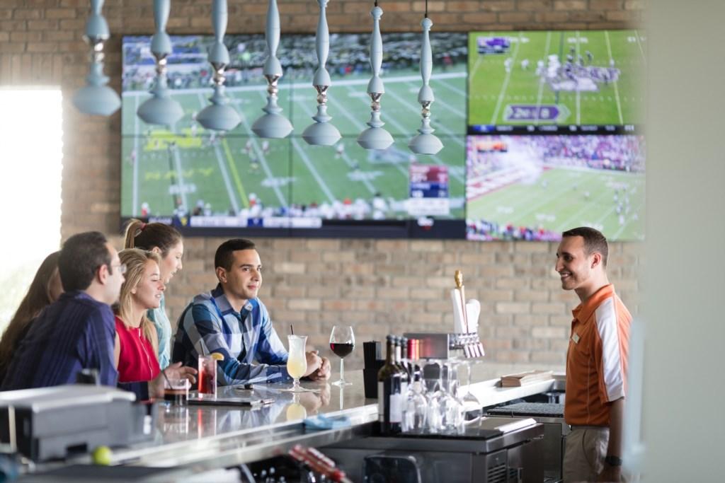Group of friends enjoying drinks at the Shark Lounge bar at Encore Resort