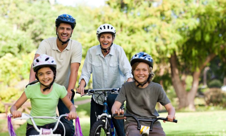 Mom, dad, and kids riding bicycles.