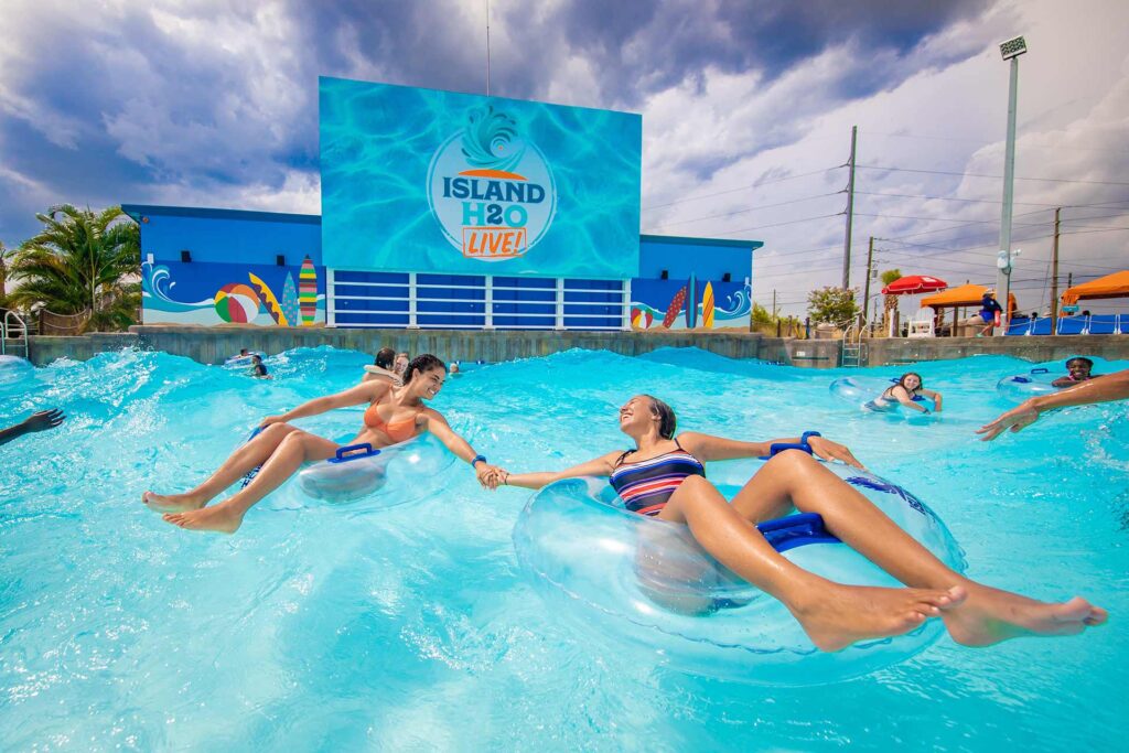 Two friends having fun in the wave pool at Island H2O Water Park