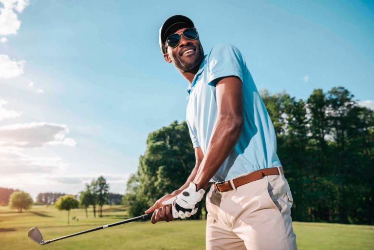 Man holding a golf club on a green