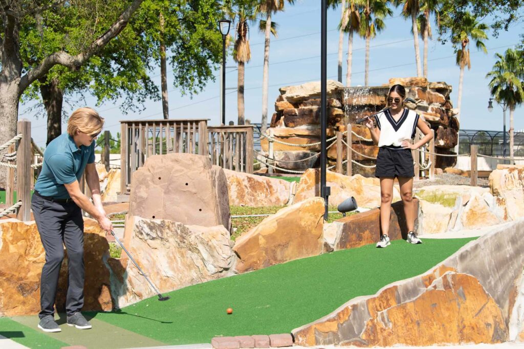 Couple playing a round of miniature golf at Reunion Resort