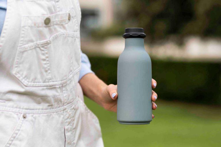 Woman holding a reusable water bottle