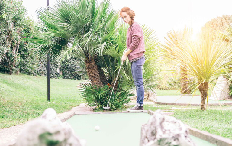 Woman putting for mini golf