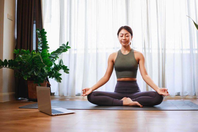 Woman participating in an online yoga class